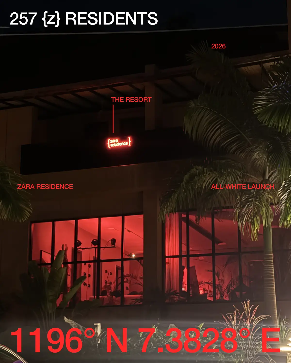 The resort exterior at night, lit red